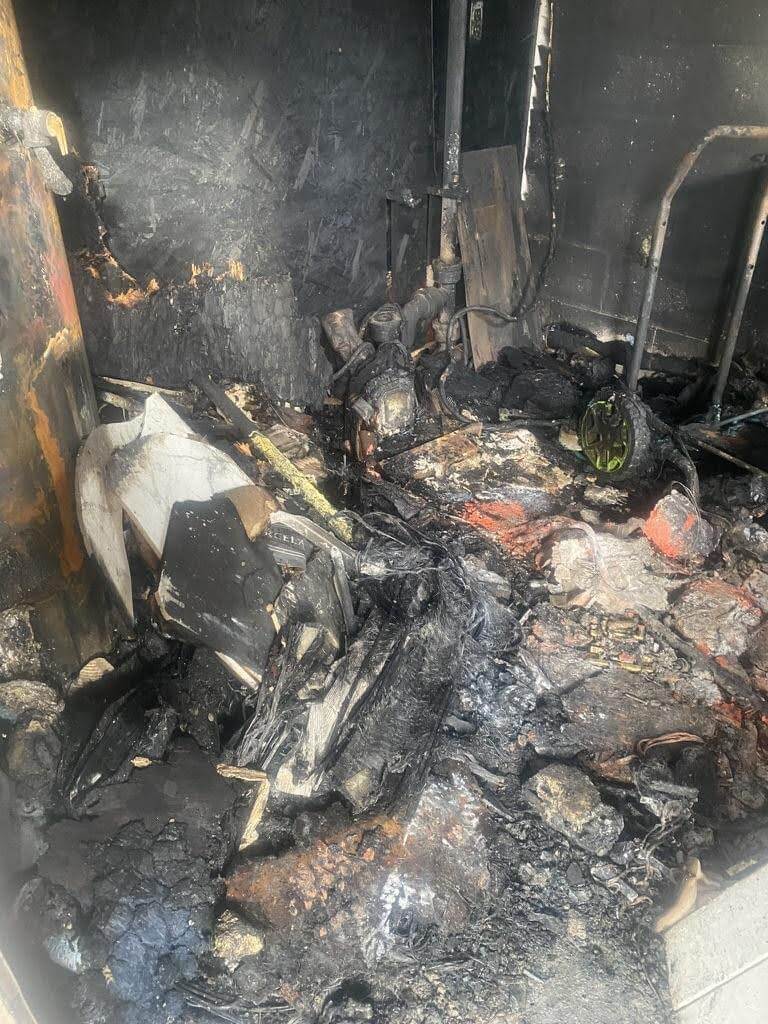 Fire damage inside home with blackened walls and burned debris