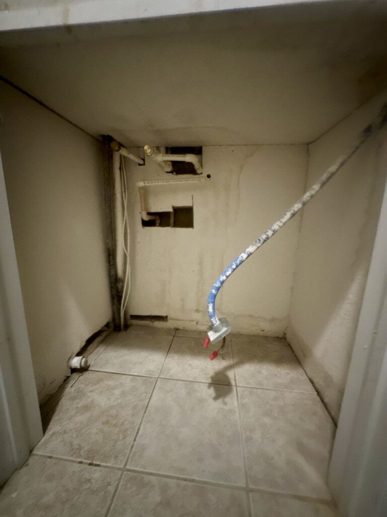 Underside of an HVAC air handler support platform showing water damage and mold conditions in a Volusia County home