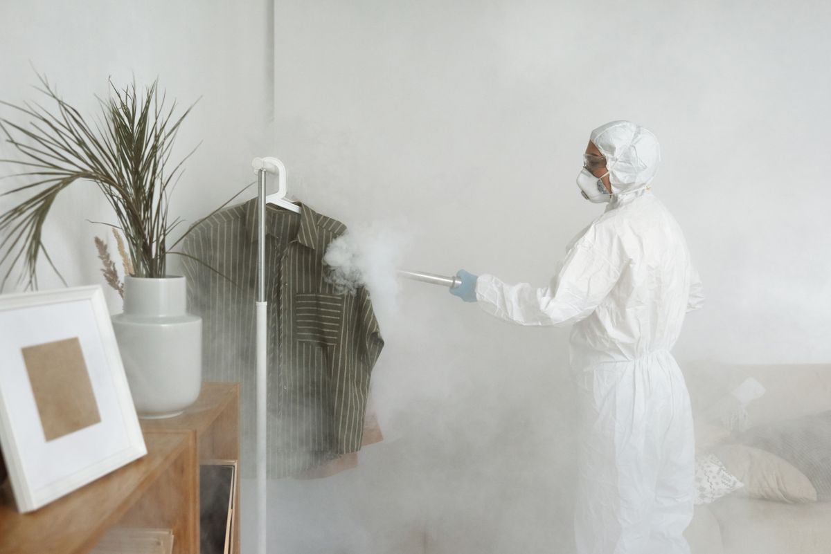 Fumigation Disinfection Device Technician using a fumigation device for biohazard decontamination